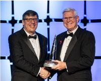 Michael Coats (right) presents the 2024 National Space Trophy to Christopher Scolese
