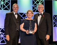 Pam Melroy (center) receiving the National Space Trophy, presented by Stephen Koerner (left) and Mike Coats (right). Pam Melroy (center) receiving the National Space Trophy, presented by Stephen Koerner (left) and Mike Coats (right).