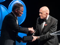 David Thompson receives the Omega Watch from Thomas Stafford during the 33rd annual RNASA Banquet