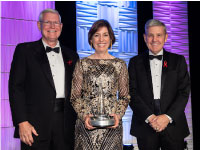 Michael Coats (left) and Robert Cabana (right) present the 2020/2022 National Space Trophy to former JSC center Director, Ellen Ochoa (center).