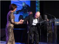 Lt. Gen. Thomas Stafford presents the OMEGA speedmaster watch to Dr. Ellen Ochoa.