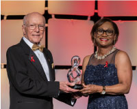 Vanessa Wyche (right) presents Gerald Griffin the 2024 Corona Award